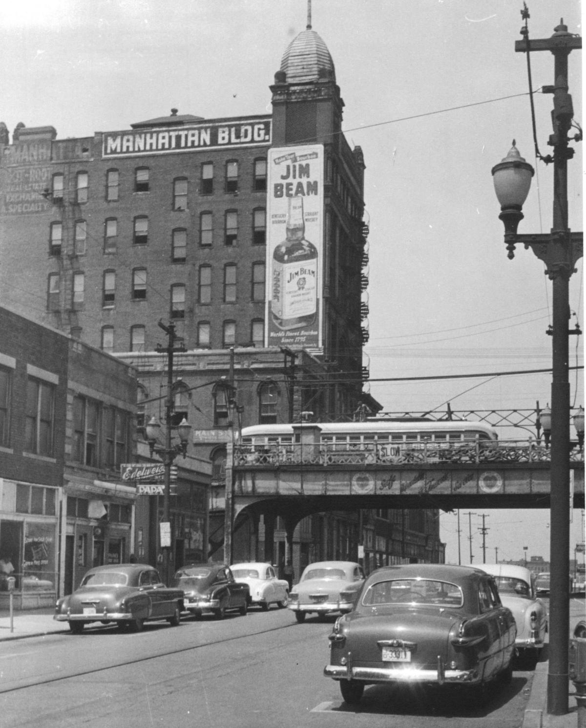 An elevated streetcar crossed over Main Street near 8th Street in downtown Kansas City in the mid-20th century.