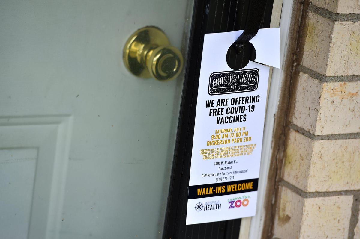 The Springfield-Greene County Health Department sent people door-to-door in a north Springfield neighborhood Thursday, July 15, 2021, alerting residents to a vaccination event at the nearby zoo. They placed about 100 door hangers in the area. As Missouri hits a wall in vaccinations, prompting a rapid spread of the deadlier COVID variant, health officials have turned to a painstaking and personalized outreach efforts.