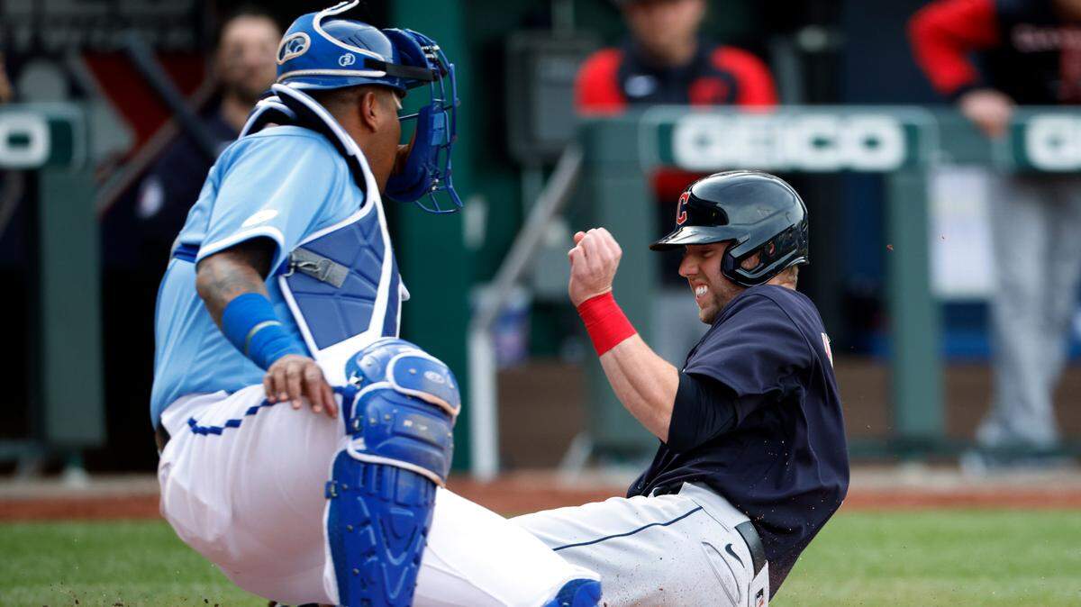 Kansas City Royals catcher Salvador Perez, left, tags out Cleveland Guardians’ Owen Miller at home plate during the 10th inning of a baseball game in Kansas City, Mo., Saturday, April 9, 2022. (AP Photo/Colin E. Braley)