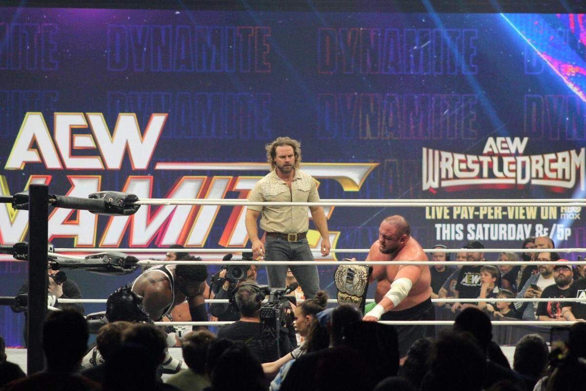 AEW Men’s World Champion “Hangman” Adam Page stares at No. 1 contender Samoa Joe holding his championship ahead of their title match Saturday, Oct. 18 at WrestleDream in St. Louis.