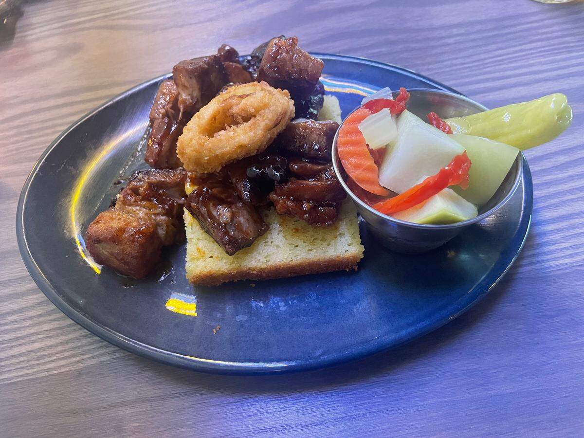 The pork belly burnt ends are served atop house-made cornbread at Third Street Social.