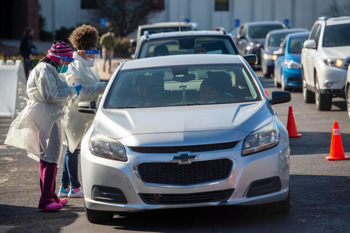 Medical worker Jameisha Carr, left, and Adania Ivory, an RN-MSN, both from Swope Health, administered COVID-19 tests during a drive-through clinic Wednesday, Nov. 18, 2020, at Holmeswood Baptist Church in Kansas City. The site was hoping to test between 150 and 200 people. The testing was run in conjunction with the Kansas City Health Department.