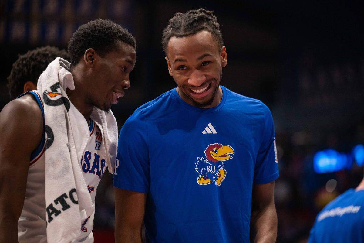 Kansas Jayhawks guards Melvin Council Jr. (14) and Darryn Peterson (22) share a laugh in the second half vs. the Towson Tigers on Tuesday, December 16, 2025, at Allen Fieldhouse.
