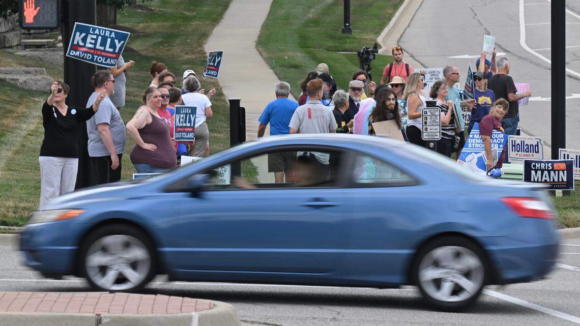 Democrats protested outside a rally at Embassy Suites in Olathe on Sunday, where Florida Gov. Ron DeSantis campaigned for Attorney General Derek Schmidt, the GOP nominee for Kansas governor.