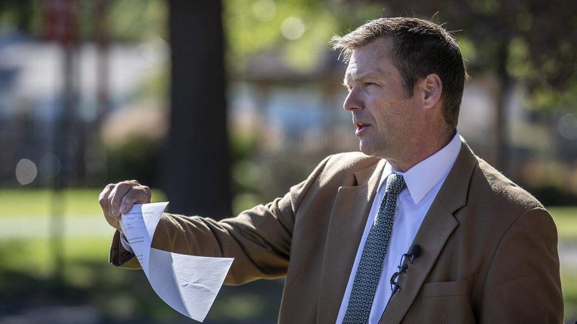 Kris Kobach holds a copy of a Roeland Park Police Department policy establishing Roeland Park as a sanctuary city Tuesday, Oct. 8, 2019, outside the Roeland Park Community Center. “It’s a sad day for Kansas,” he said, “when one of its cities says, ‘We are putting the interests of illegal aliens over the safety of U.S. citizens in our city.” Kobach, who is running for U.S. Senate, said that aside from a couple of Kansas counties, Roeland Park is the first city in the state to announce a sanctuary policy.