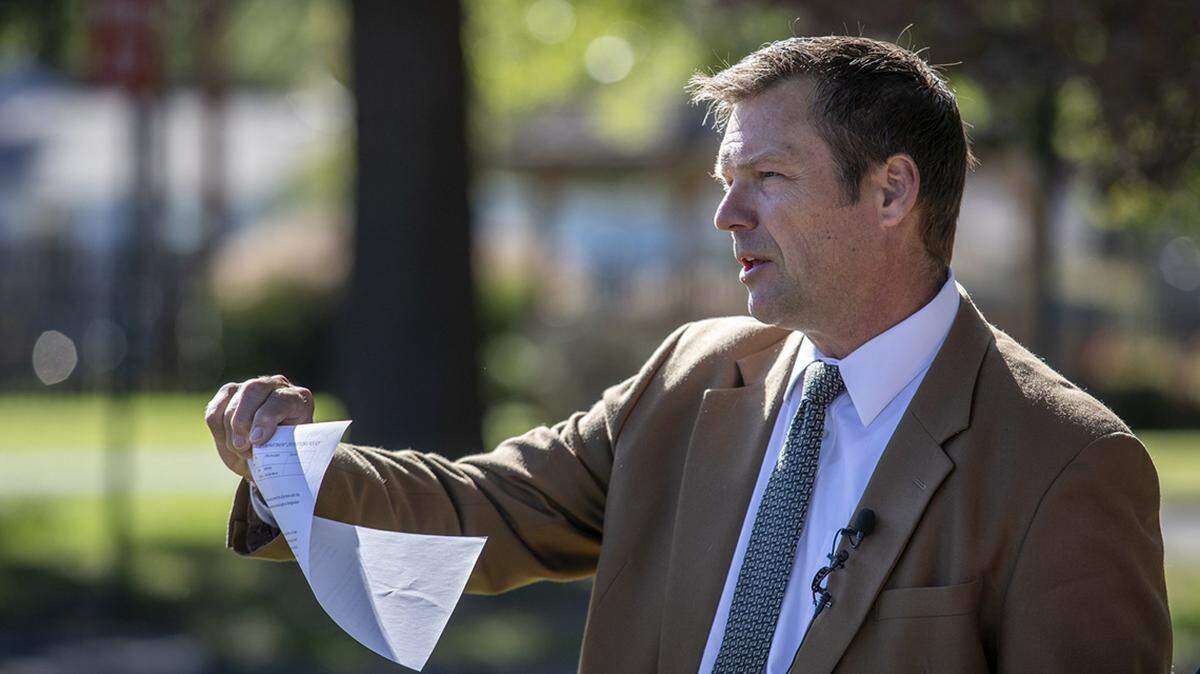 Kris Kobach holds a copy of a Roeland Park Police Department policy establishing Roeland Park as a sanctuary city Tuesday, Oct. 8, 2019, outside the Roeland Park Community Center. “It’s a sad day for Kansas,” he said, “when one of its cities says, ‘We are putting the interests of illegal aliens over the safety of U.S. citizens in our city.” Kobach, who is running for U.S. Senate, said that aside from a couple of Kansas counties, Roeland Park is the first city in the state to announce a sanctuary policy.