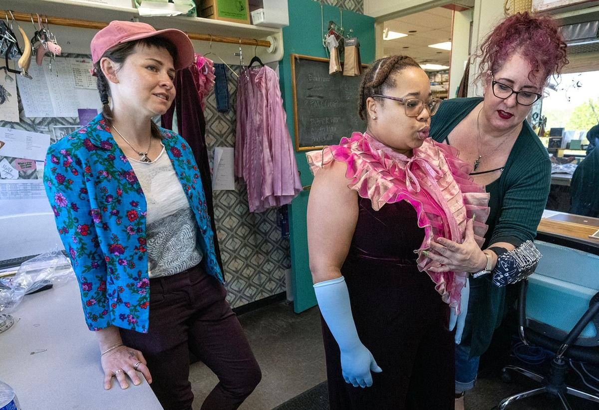 Sully Ratke, left, costume designer for the KC Rep, looks on as actor Shon Ruffin is fitted by Jana Jessee, a cutter/draper, for her costume for the “Little House of Horrors.”