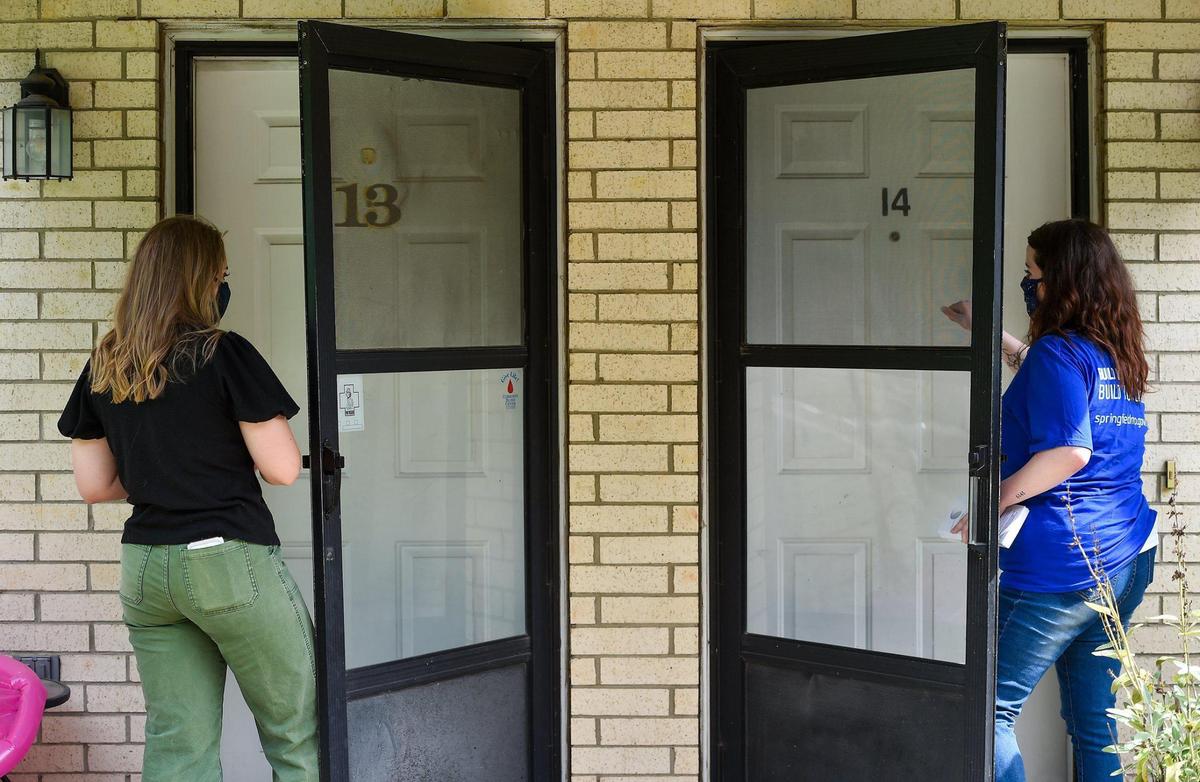Annaliese Schroeder, left, a community health advocate, and Kelsey Conner, a public health information specialist, canvass a north Springfield neighborhood Thursday, July 15, 2021, for the Springfield-Greene County Health Department in the hopes of boosting COVID-19 vaccinations. As Missouri hits a wall in vaccinations, prompting a rapid spread of the deadlier COVID variant, health officials have turned to a painstaking and personalized outreach effort including door-to-door engagement and partnerships with trusted community leaders.