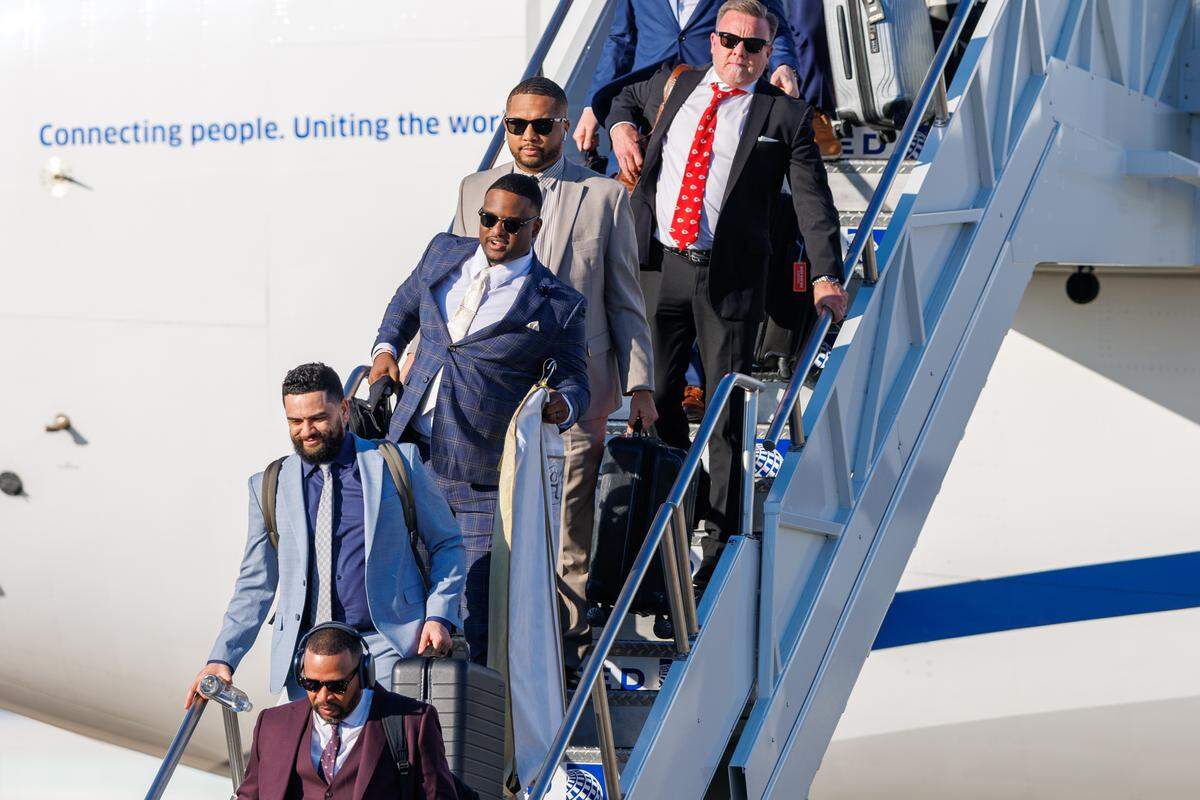 Members of the Kansas City Chiefs exit the plane after arriving at Louis Armstrong New Orleans International Airport on Feb. 2, 2025.