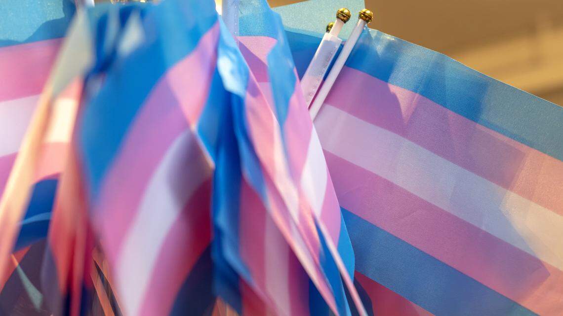 Transgender pride flags rest on a table during a Trans Day of Remembrance event at Spirit of Hope MCC on Tuesday, March 31, 2026, in Kansas City.