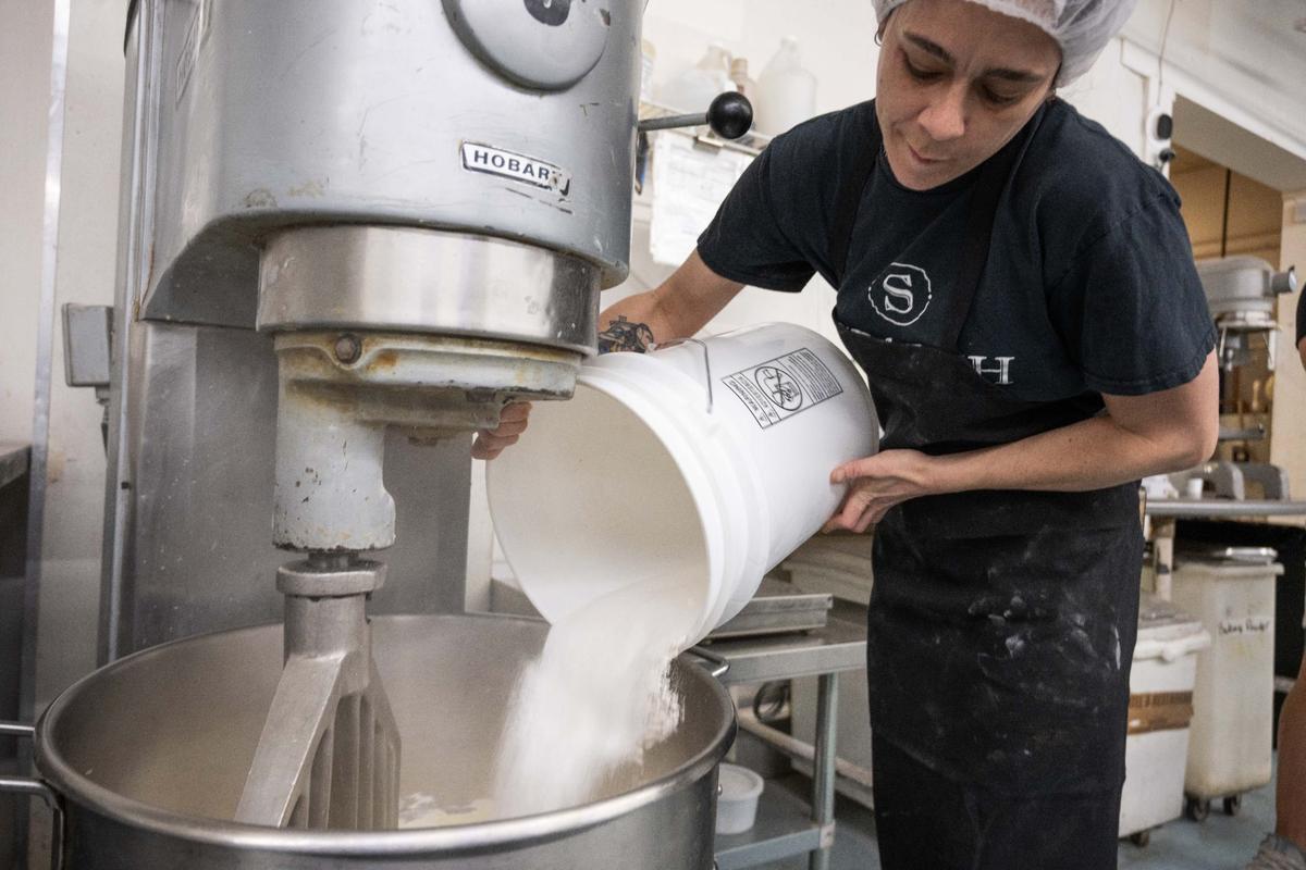 Kat Workman, Scratch KC’s vice president of production, folds sugar into an industrial-sized mixer. Some of the bakery’s top products include energy balls, cookies and, around the holidays, pies.