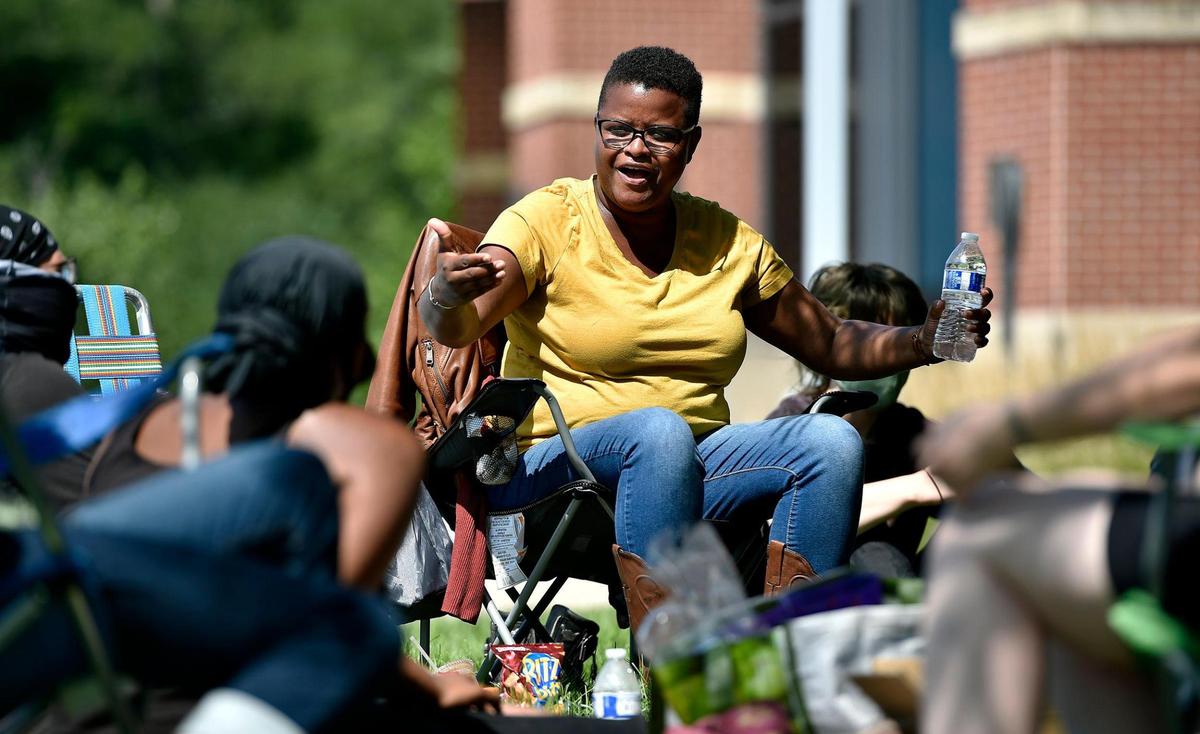 Kansas City attorney and activist Stacy Shaw, center, has become one of the leaders in the movement to end systemic racism. On Wednesday, Aug. 5, 2020, Shaw and others “camp” outside Metro Patrol station and hold what Shaw calls a jail support action for a 21-year-old who was arrested for expired tags and who Kansas City police detained for 24 hours without access to a lawyer.