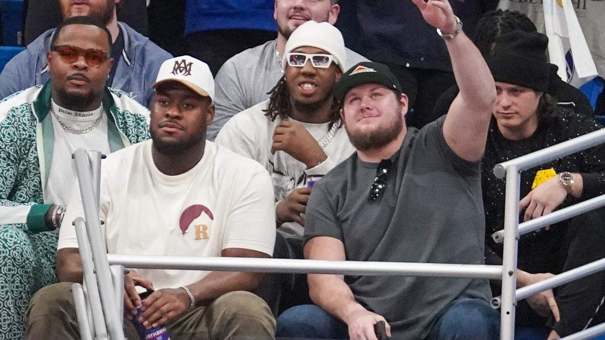 Kansas City Chiefs players Trey Smith (left) and Creed Humphrey watch the second half of the game between the Kansas Jayhawks and Oklahoma State Cowboys at Allen Fieldhouse.