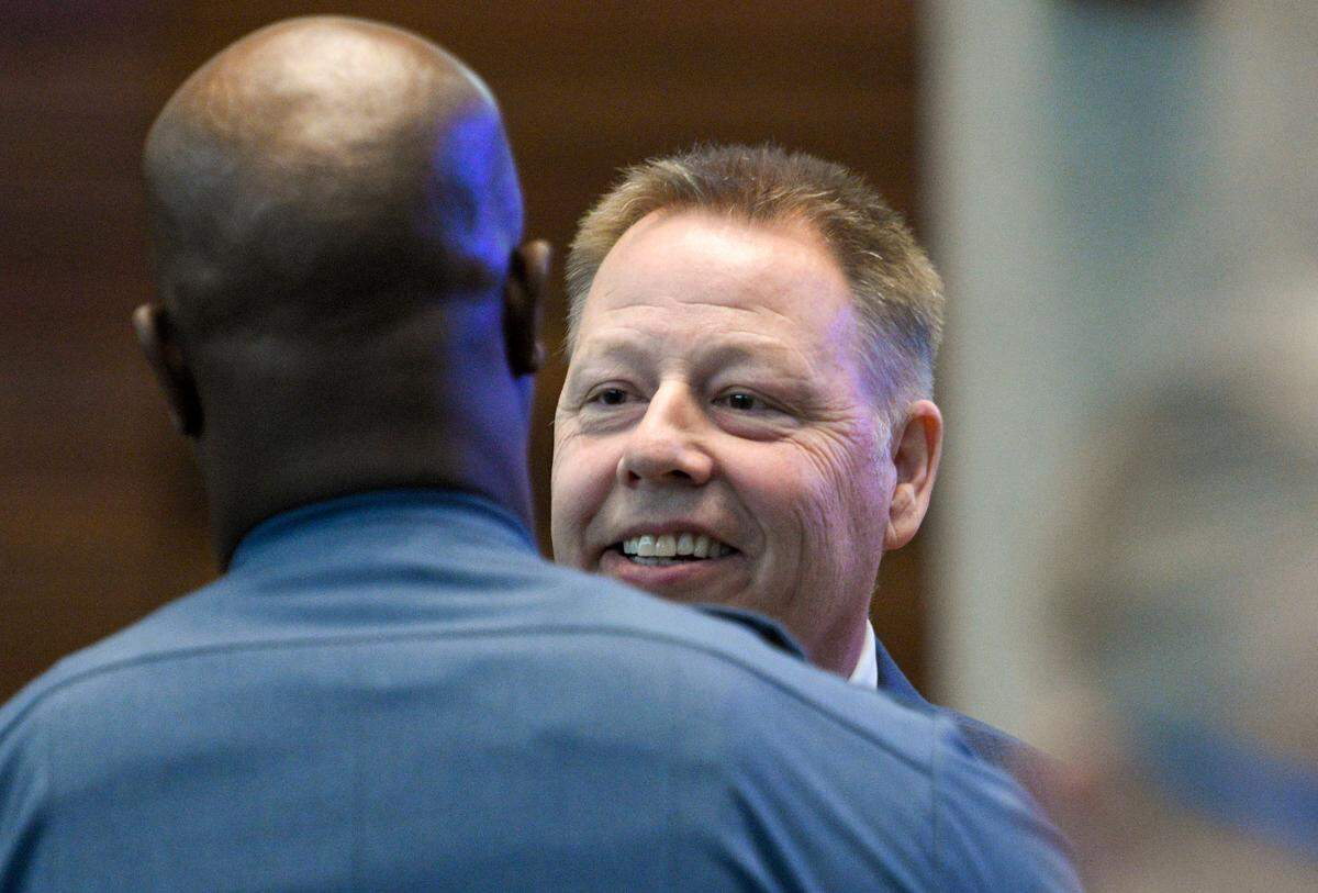 A member of the Kansas City Police Department greets Police Chief Rick Smith after the Board of Police Commissioners meeting on Tuesday, Feb. 22, 2022, at Kansas City Police Headquarters, 1125 Locust St. Smith, who was appointed police chief in August 2017, will step down this spring.
