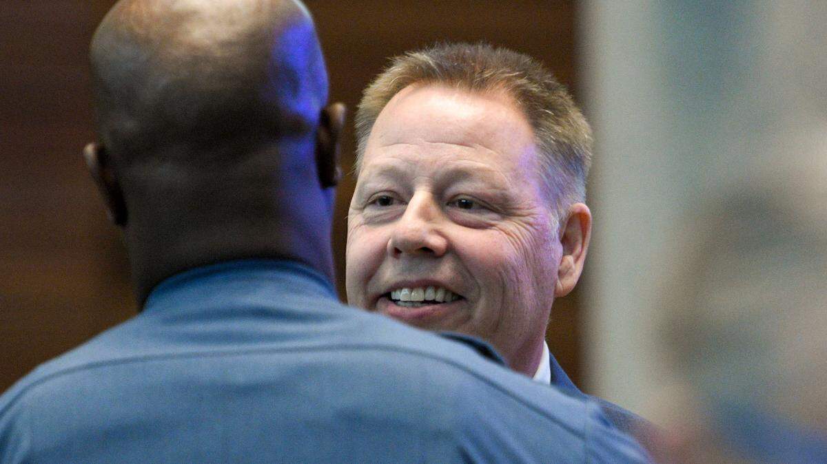 A member of the Kansas City Police Department greets Police Chief Rick Smith after the Board of Police Commissioners meeting on Tuesday, Feb. 22, 2022.