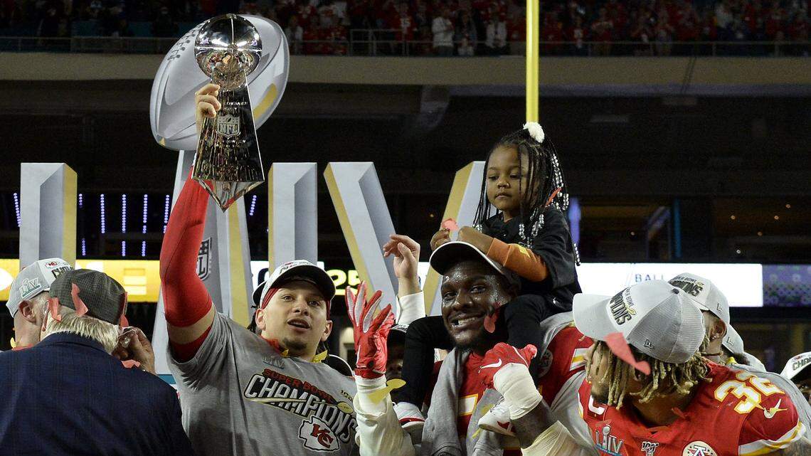 With Kansas City Chiefs defensive end Frank Clark and safety Tyrann Mathieu taking in the moment, quarterback Patrick Mahomes hoists the Vince Lombardi trophy after the Chiefs defeated the San Francisco 49ers 31-20 during Super Bowl LIV at Hard Rock Stadium in Miami Feb. 2, 2020.