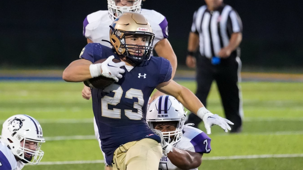 St. Thomas Aquinas running back Cal Arndt eludes Blue Valley Northwest tacklers en route to 188 rushing yards in a 28-14 win.