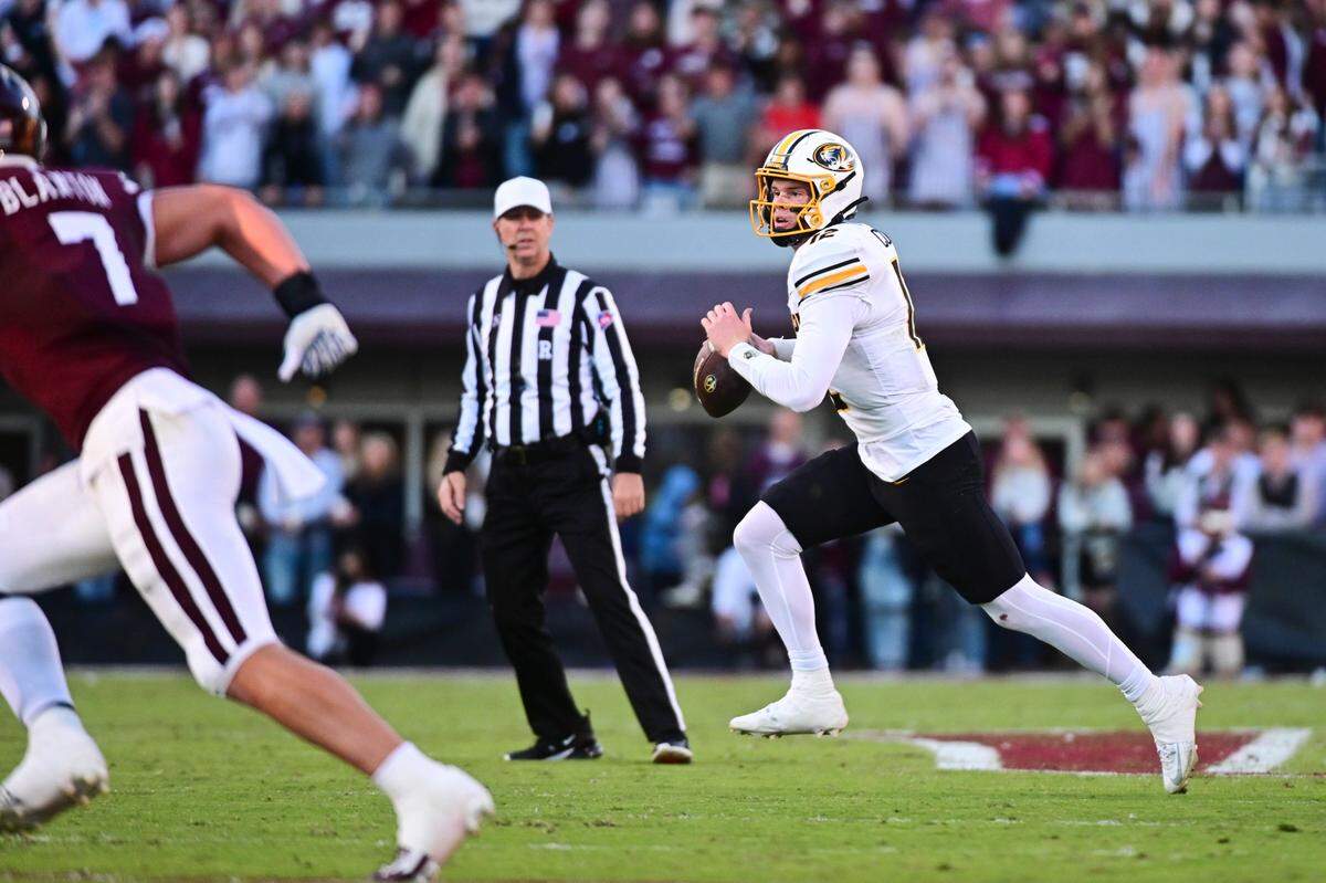 Missouri Tigers quarterback Brady Cook scrambles against the Mississippi State Bulldogs during an SEC college football game at Davis Wade Stadium at Scott Field on Saturday, Nov. 23, 2024 in Starkville, Mississippi.