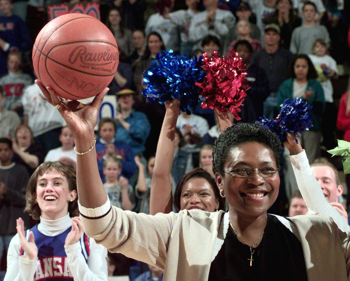 Then-University of Kansas women’s basketball coach Marian Washington acknowledges the crowd as she lifted her 500th career victory ball into the air following a win over Oklahoma on Feb. 20, 1999, in Lawrence.