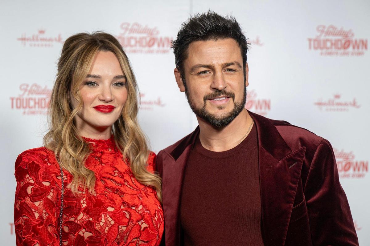 Hunter King and Tyler Hynes, the stars of Hallmark’s “Holiday Touchdown: A Chiefs Love Story,” walked the red carpet at the movie premiere on Saturday at the Sheraton Kansas City Hotel at Crown Center.