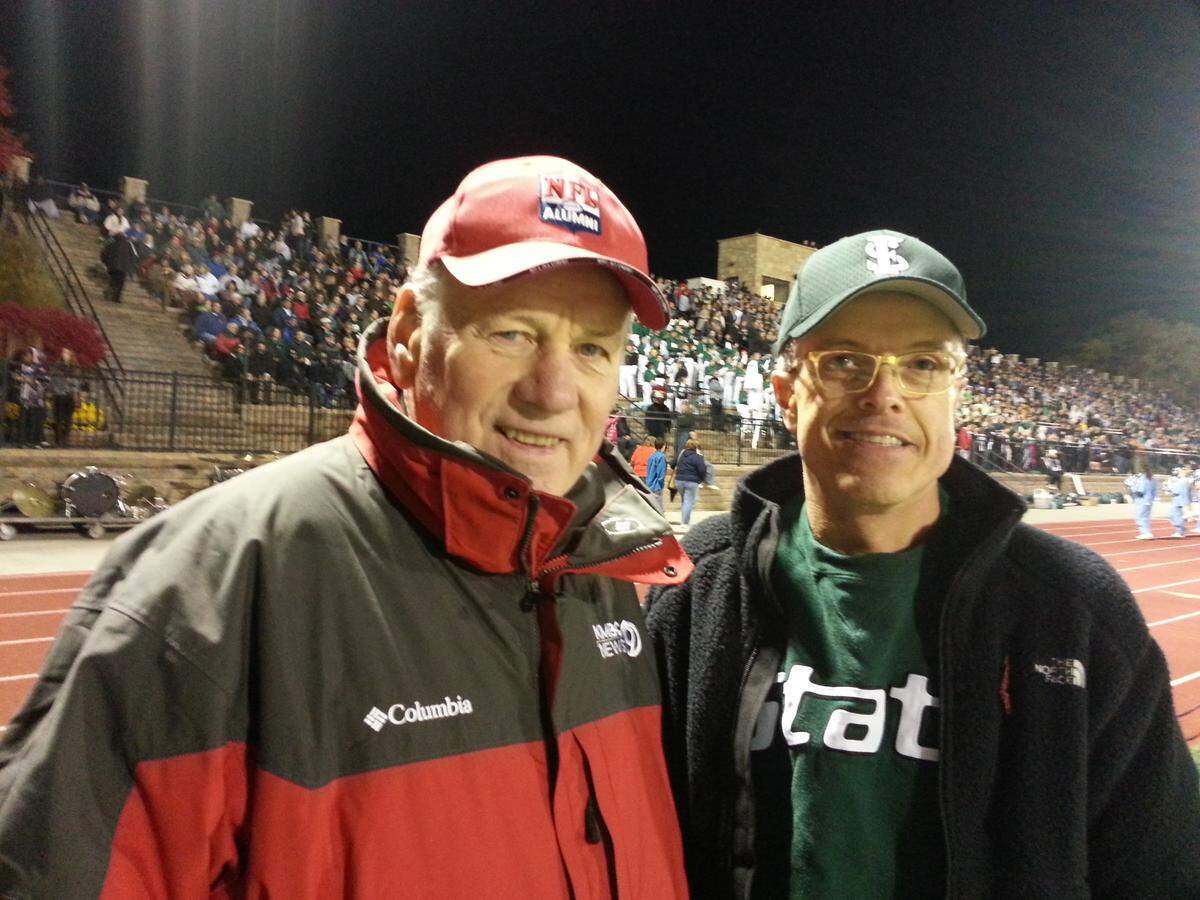 A photo of Len Dawson and John Dunham at a high school football game in Lawrence in 2013