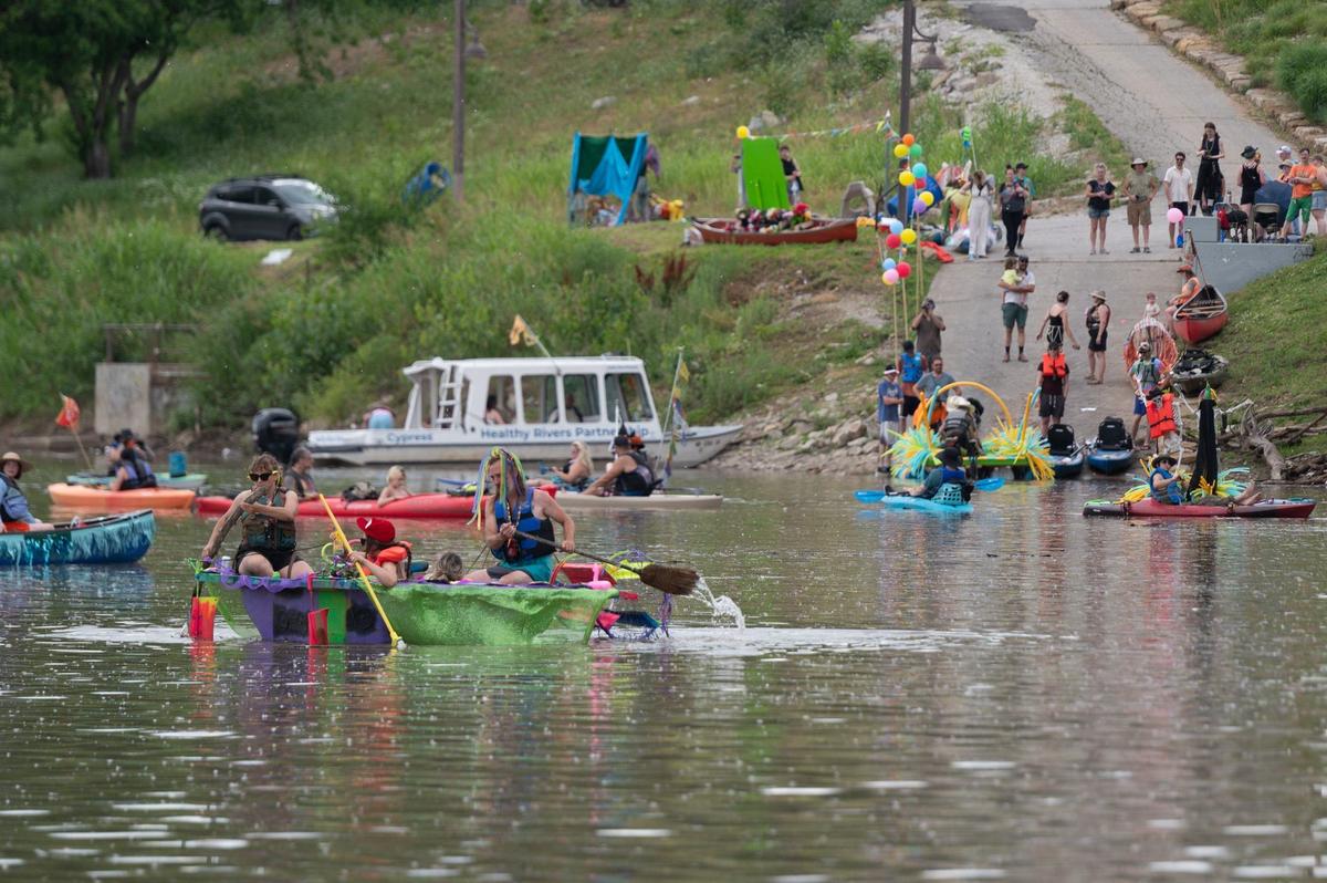 Participants in the Kawsmouth River Carnival boat parade launch their crafts Saturday from Kaw Point in Kansas City, Kansas.