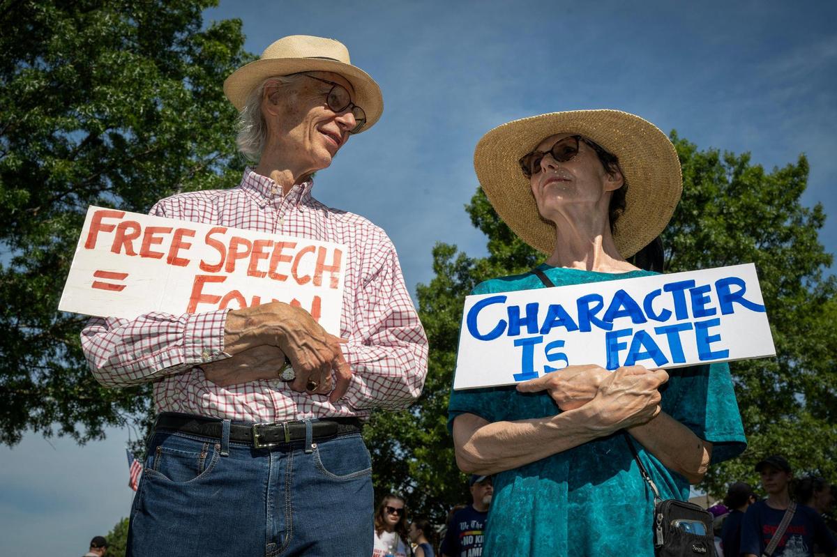 Protesters Roderick and Wyatt Townley of Johnson County, rallied as part of a nationwide “No Kings” day of defiance on Saturday, June 14, 2025, at Sar-Ko-Par Trails Park in Lenexa, Kansas. The events protest President Donald Trump and immigration policies, among other issues.