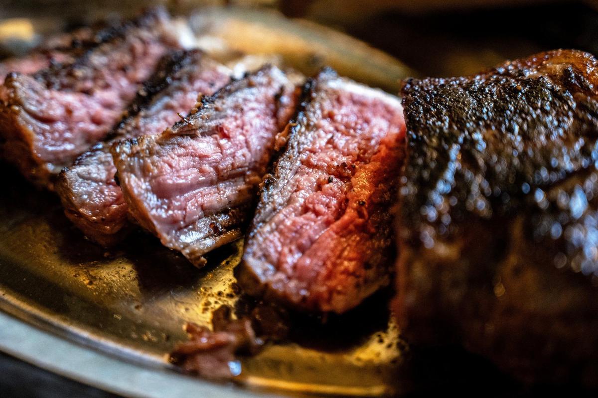 A cut strip steak is served at Jess and Jim’s Steakhouse. It’s the restaurant’s policy not to serve steak well done.