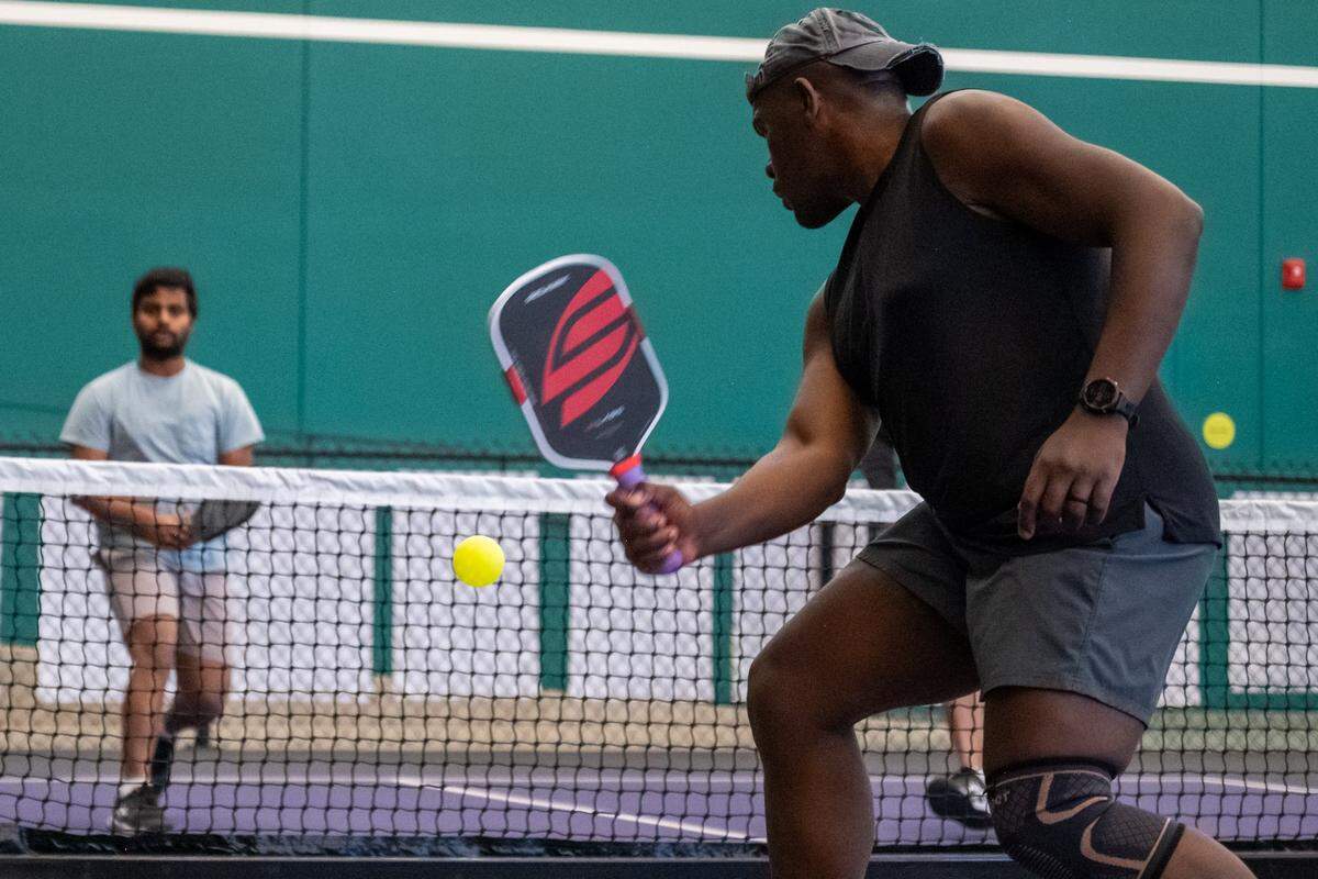 Beni Chikuru prepares to return a volley during a meeting of the Black Pickleball Club at SW19 at the Stadium, on Sunday, February 22, 2026, in Kansas City. The club, started by Brandan Jackson, hosts weekly meetups every Sunday as a space for Black people to participate in pickleball.