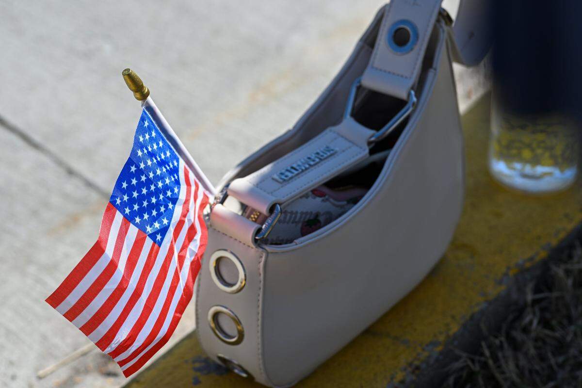A small American flag is tucked into a purse during a No Kings protest against the Trump administration in Mill Creek Park near the Country Club Plaza on Saturday, March 28, 2026.
