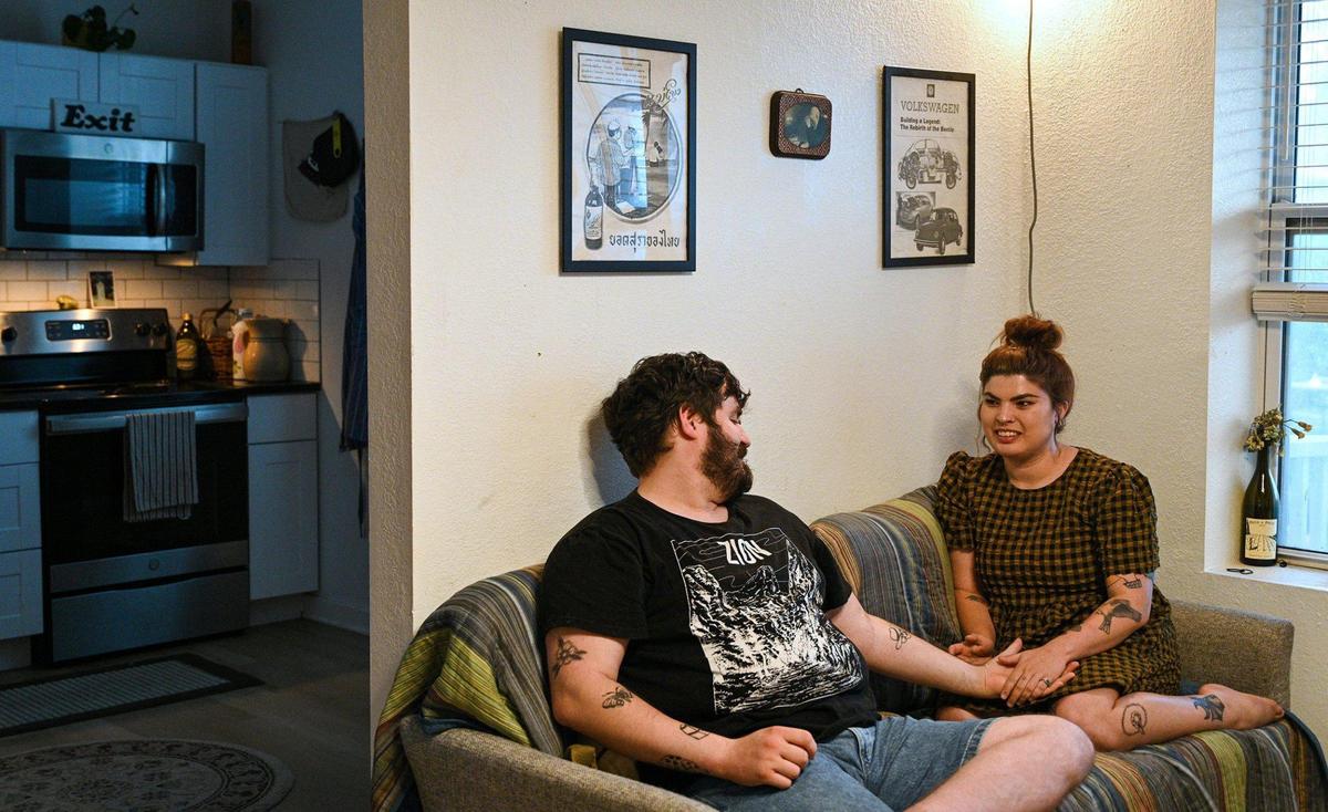 Edward Griffin and partner Ashley Ellerman are pictured in their Kansas City apartment. After struggling to open up about their past, Griffin said they are glad to have Ellerman to confide in.