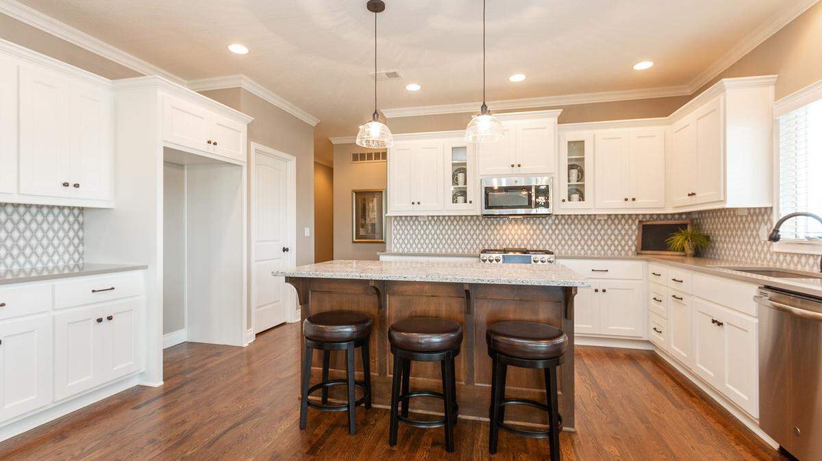 The Ensley II plan offers a gourmet kitchen with luxurious finishes and plenty of room to prepare meals and entertain guests.