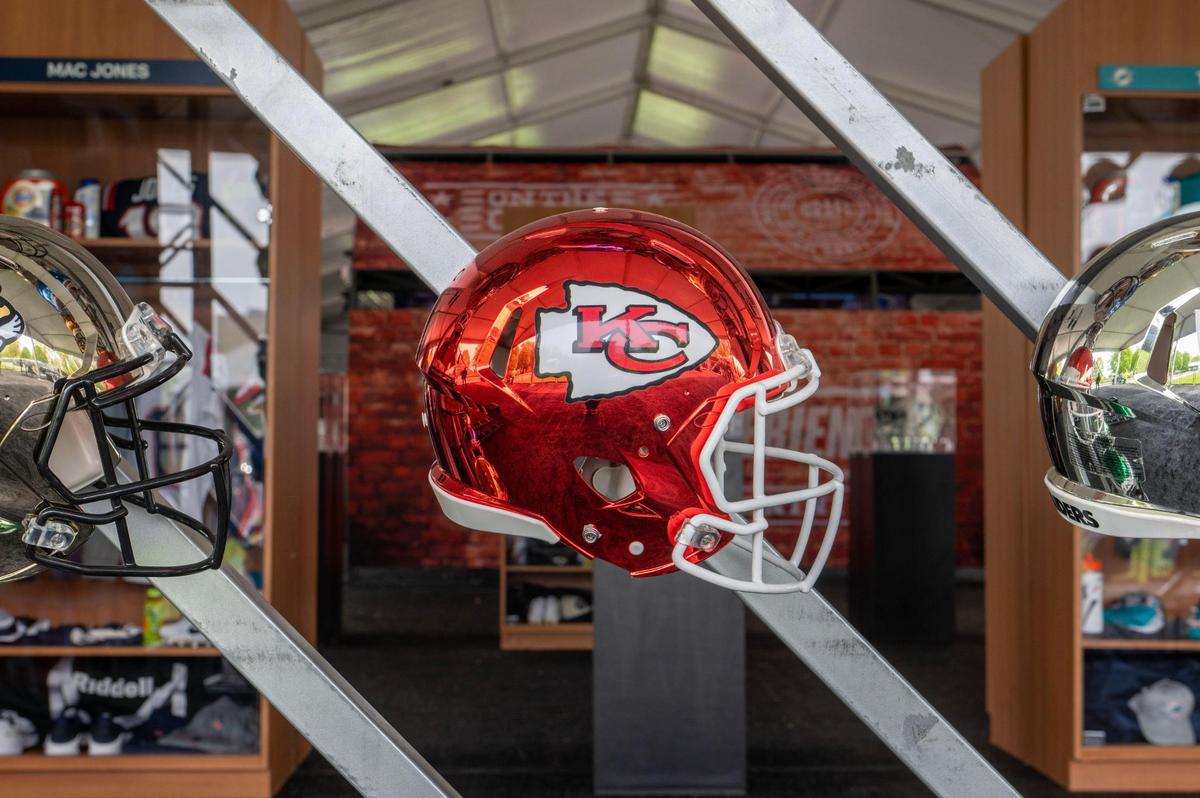 A metallic Kansas City Chiefs helmet is displayed at the NFL Draft Experience gallery.