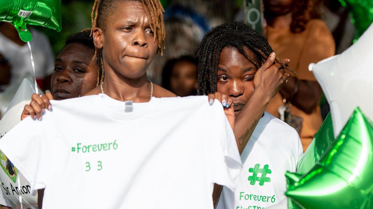 Shyneisha Hill, the godmother of 6-year-old Sir’Antonio Brown, wipes a tear from her face during a vigil on Wednesday, May 10, 2023, in Kansas City, Kan. Brown was killed May 3 while playing outside his home.