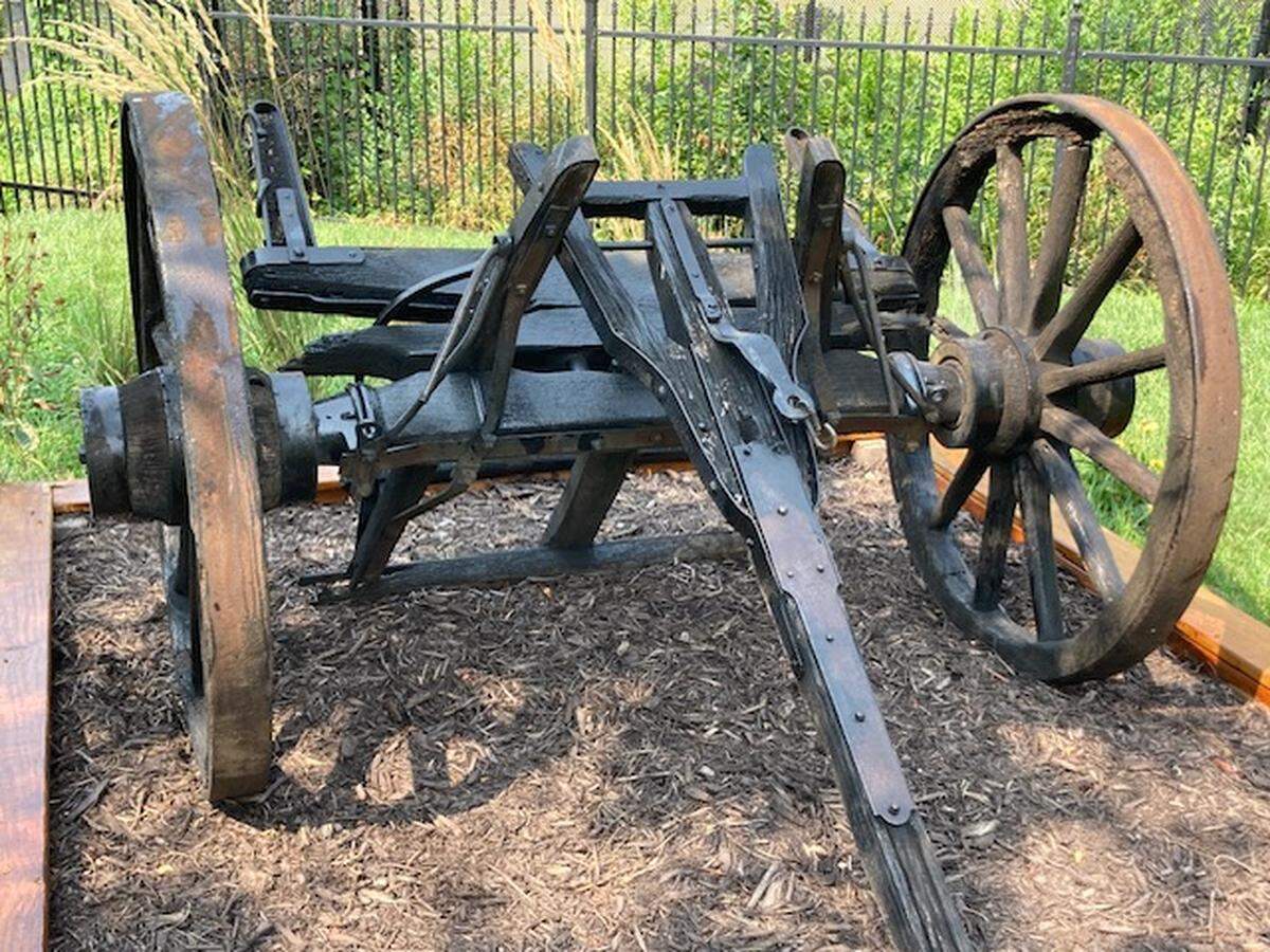 The front wheels, axle and shaft of the Conestoga-style wagon that once sat outside of the Old Westport Shopping Center, at Westport Road and Southwest Trafficway, are now on display on the grounds of the Harris-Kearney Historical House Museum.