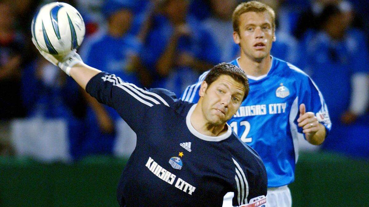 KC Wizards goalkeeper Tony Meola sends the ball downfield as teammate Jimmy Conrad (12) heads the same direction during an October 4, 2003, soccer match between the Wizards and Colorado Rapids.