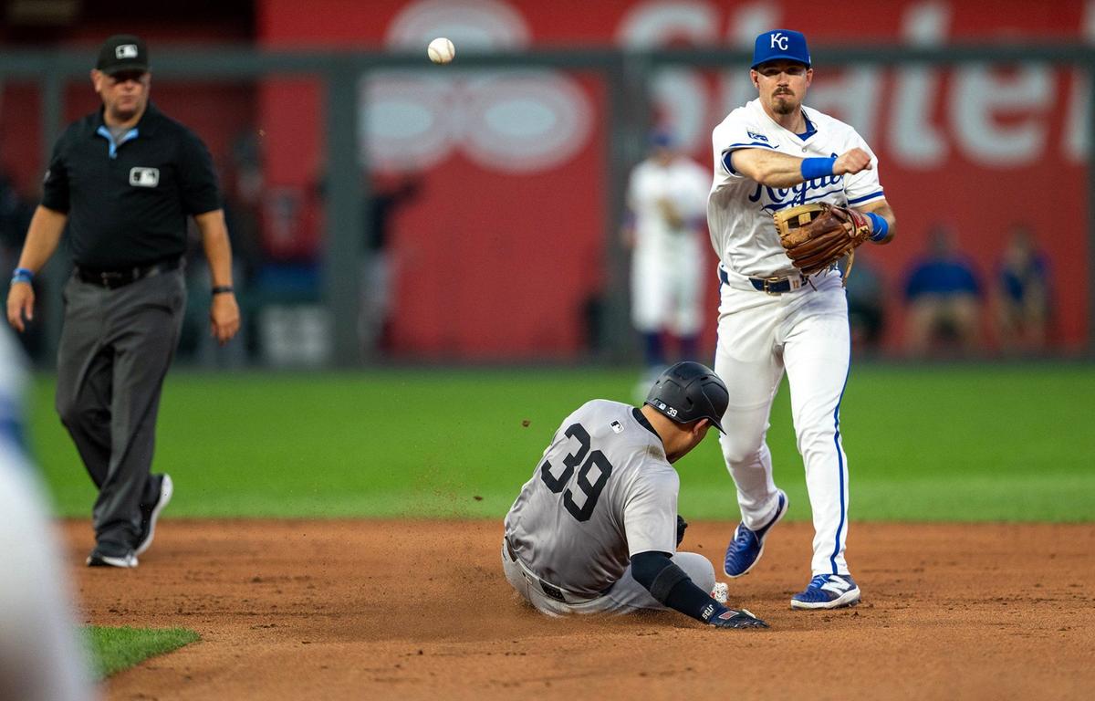 Kansas City Royals second base Nick Loftin (12) throws to first after forcing out New York Yankees catcher Jose Trevino at Kauffman Stadium on Wednesday, June 12, 2024.