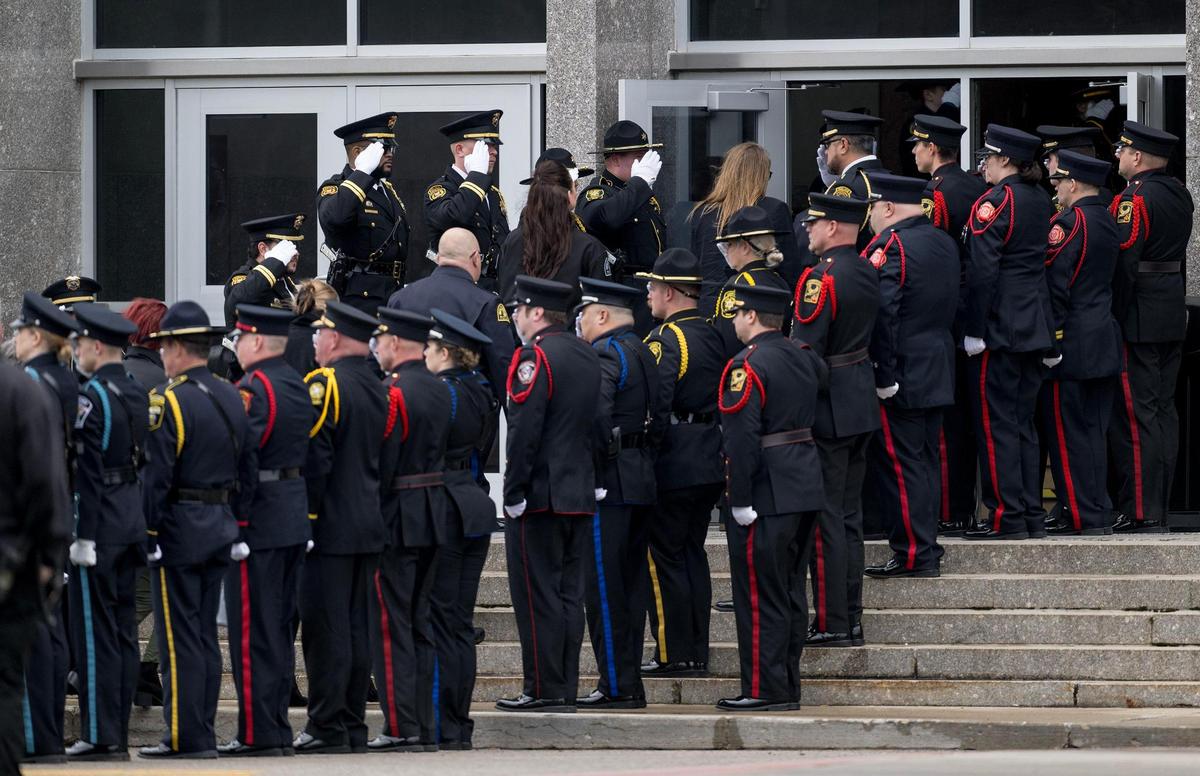 Family members and law enforcement officials enter the Community of Christ’s auditorium for the funeral of Independence police officer Cody Allen on Friday, March 8, 2024, in Independence. Allen was fatally shot during an eviction in northeast Independence last week.
