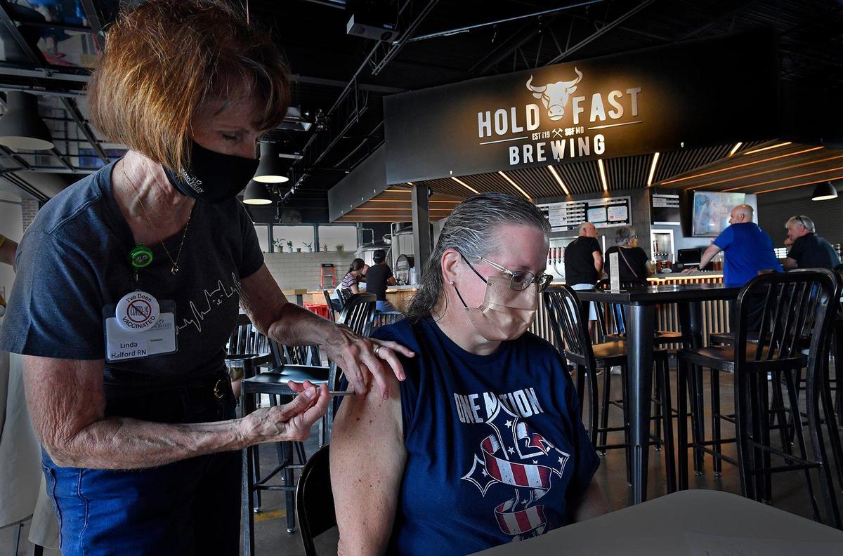 Hold Fast Brewing in Springfield hosted a COVID-19 vaccination clinic dubbed Pints and Pics for Pokes on Thursday. Sylvia Clevenger rolled up her sleeve and got the shot with the help of Linda Halford, a local registered nurse. In all, 51 people were vaccinated and treated to a free pint and portrait by a local photographer volunteering his time.