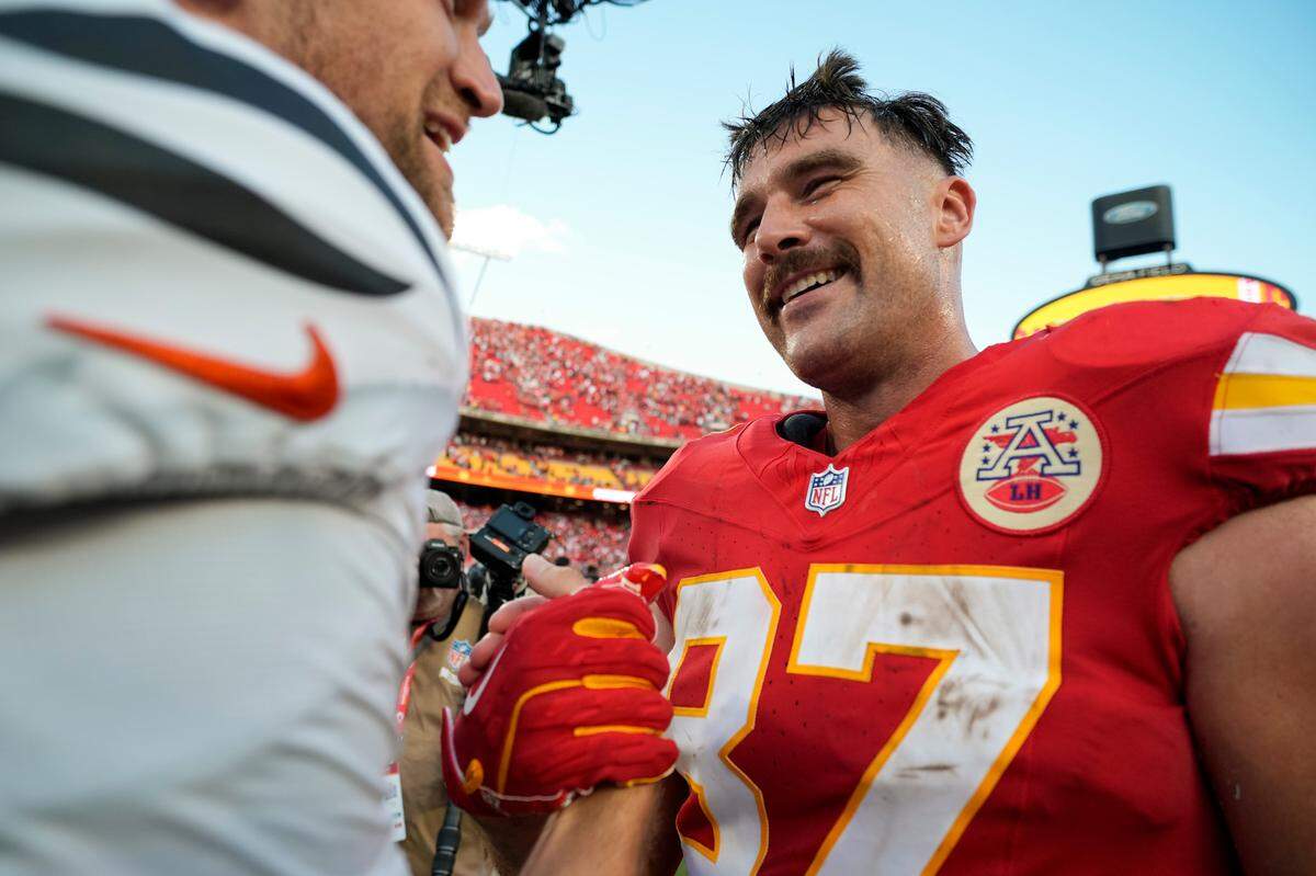 Kansas City Chiefs tight end Travis Kelce (87) talks with Cincinnati Bengals tight end Mike Gesicki (88) after a game at GEHA Field at Arrowhead Stadium.