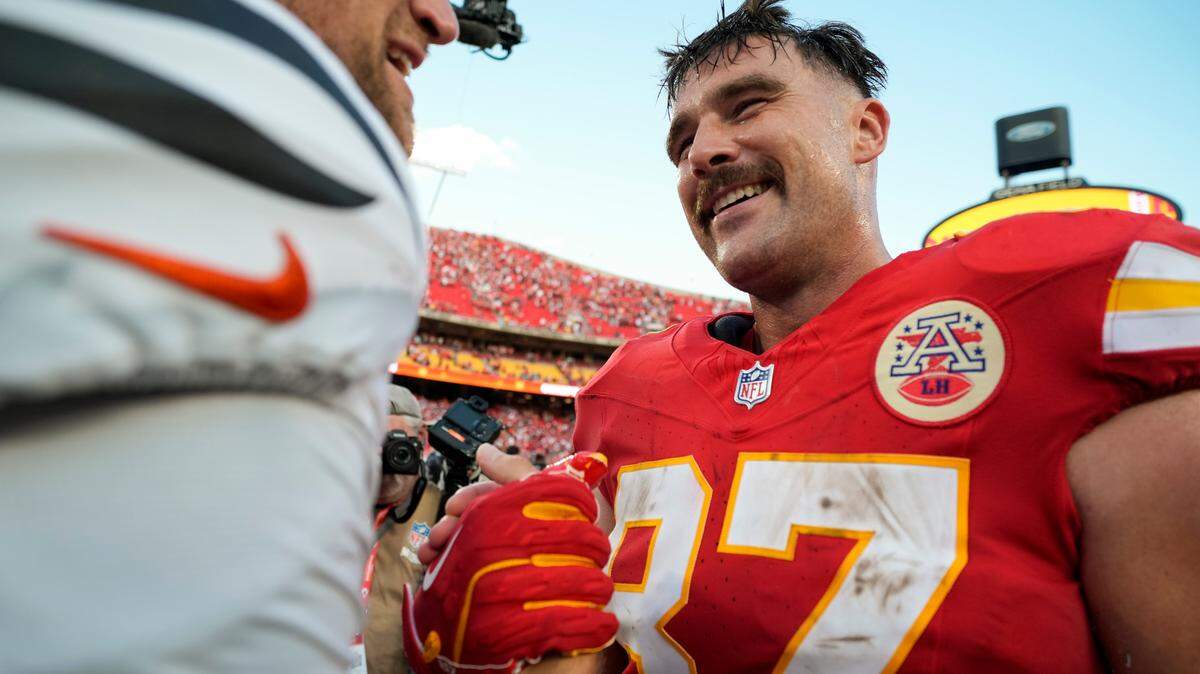 Kansas City Chiefs tight end Travis Kelce (87) talks with Cincinnati Bengals tight end Mike Gesicki (88) after a game at GEHA Field at Arrowhead Stadium.