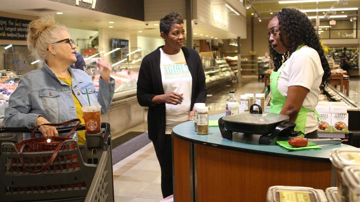 Leawood resident Marianne Brennan chats with Linda Donaldson and Kiley Williams-Bowls at Hen House Market, 11721 W. Roe Ave.