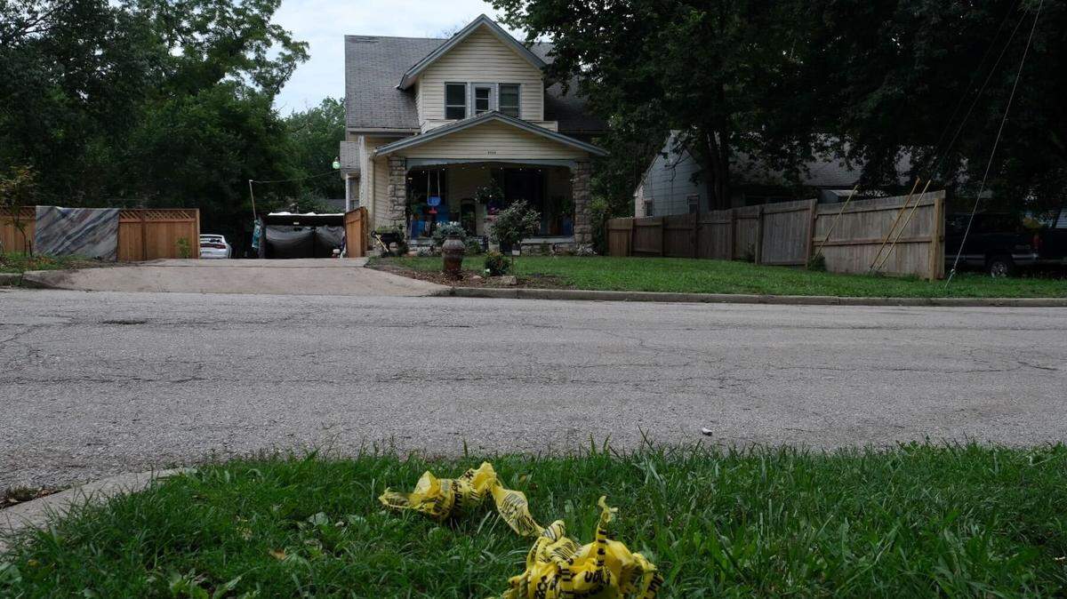 A man was killed early Tuesday when shots were fired into a home in the 6000 block of Indiana Avenue in the South Town Fork Creek neighborhood in Kansas City. Crime scene tape was wadded up into a ball and left on the lawn across the street of where the shooting occurred.