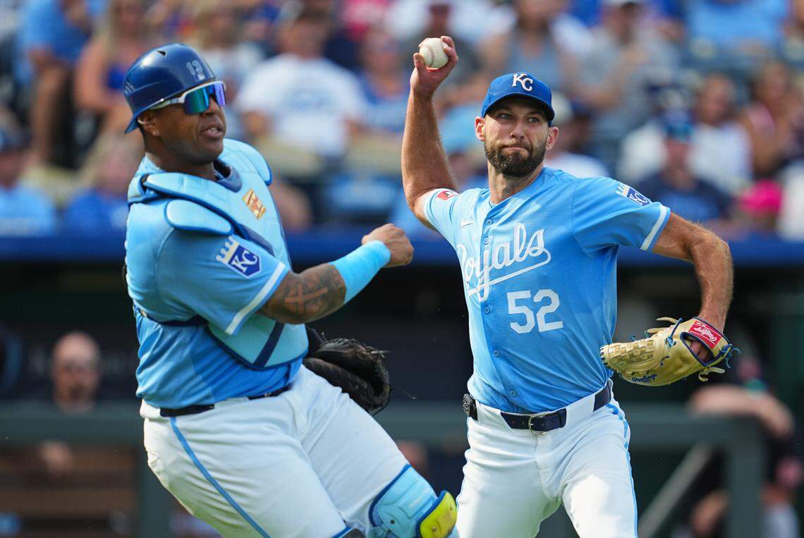 Kansas City Royals pitcher Michael Wacha, right, throws to first base alongside catcher Salvador Perez during Monday afternoon’s game against the Cleveland Guardians at Kauffman Stadium.