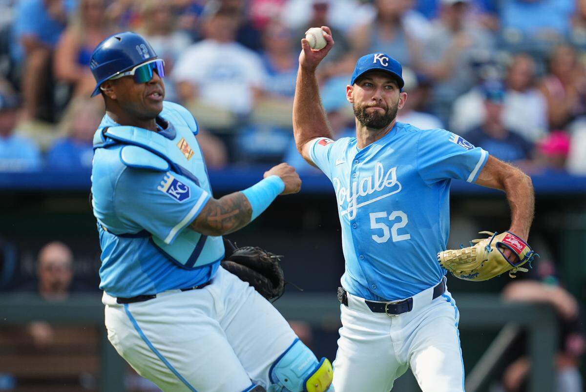 Kansas City Royals pitcher Michael Wacha, right, throws to first base alongside catcher Salvador Perez during Monday afternoon’s game against the Cleveland Guardians at Kauffman Stadium.