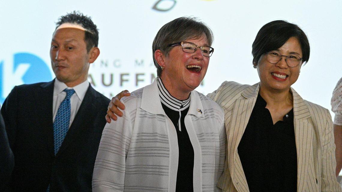 Kansas Gov. Laura Kelly, center, and Megan Myungwon Lee, chairwoman and CEO of Panasonic Corporation of North America, shared a light moment Wednesday after Kelly announced a plan to build a $4 billion Panasonic EV battery plant near De Soto. Panasonic Energy’s executive vice president, Kris Takamoto, left, spoke at the event.