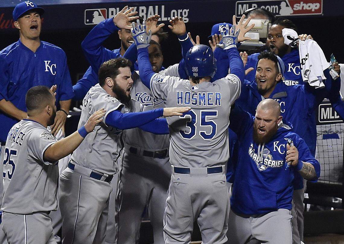 Kansas City Royals first baseman Eric Hosmer is swarmed by teammates after he scored the tying run in the ninth inning during Game 5 of the World Series on Sunday, November 1, 2015 at Citi Field in New York.