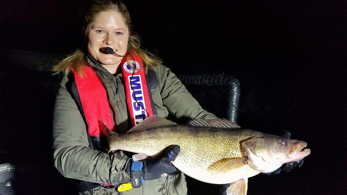 Cassandra Messer, technician for the Missouri Department of Conservation, holds a 27.5-inch female walleye that was netted during the electroshocking walleye sampling on Longview Lake.