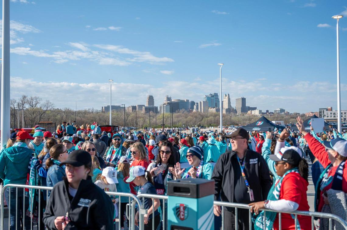 With the Kansas City skyline in the distance, Kansas City soccer fans wait to get into CPKC Stadium to watch the Kansas City Current play the Portland Thorns in the inaugural game at the stadium on Saturday, March 16, 2024.