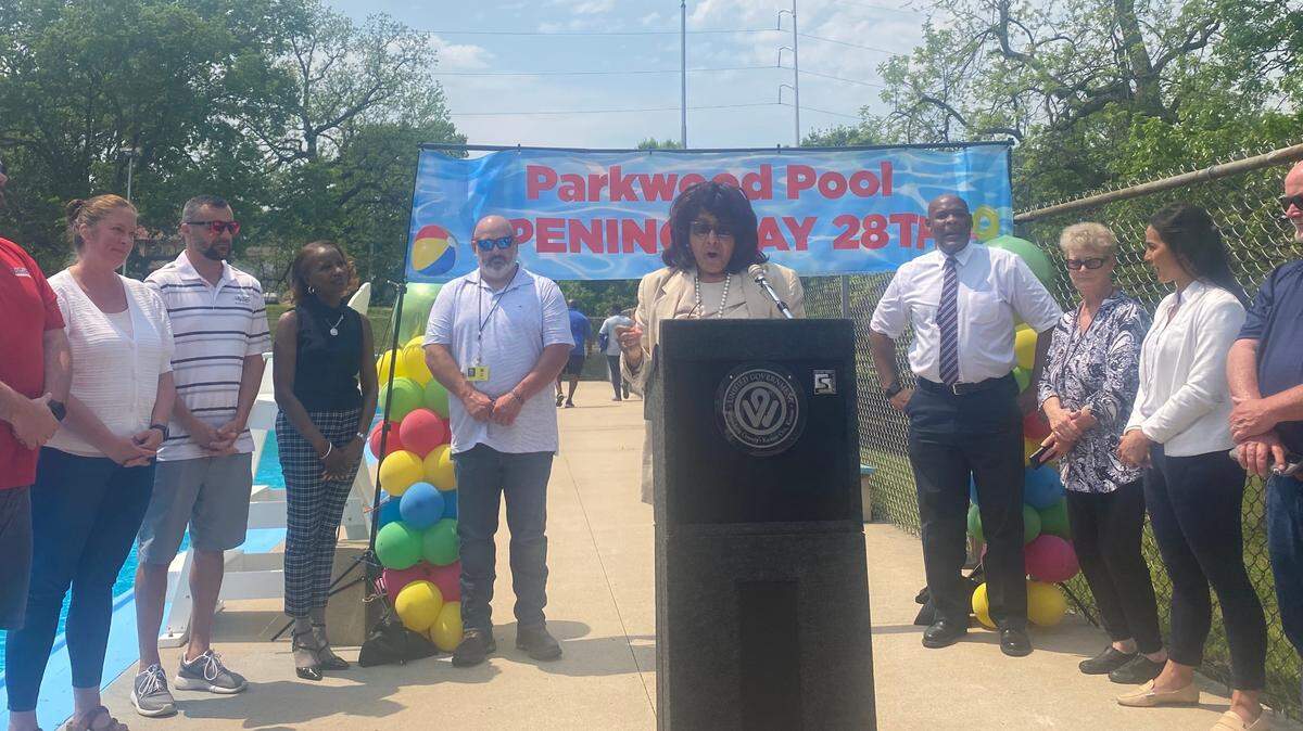 Unified Government Commissioner Gayle Townsend, District 1, is surrounded by Mayor Tyrone Garner and other Unified Government officials on Tuesday afternoon in announcing the reopening of Parkwood Pool during the summer.